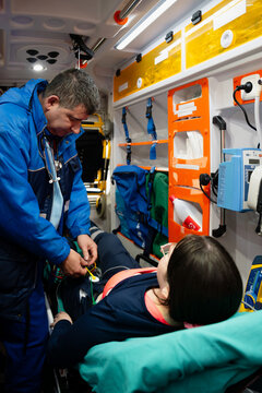 Paramedic Treating Patient On Stretcher
