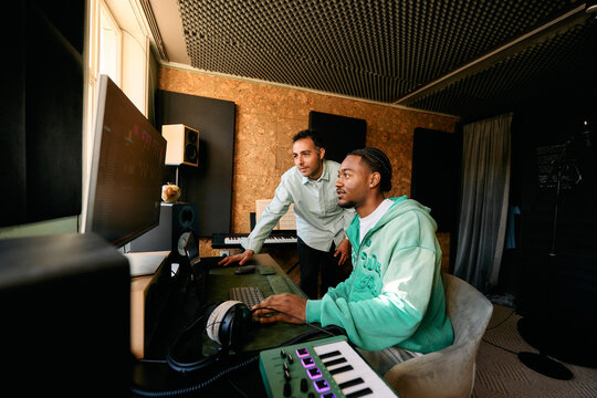 Music Producers Collaborating on Audio Project. Home Recording Studio