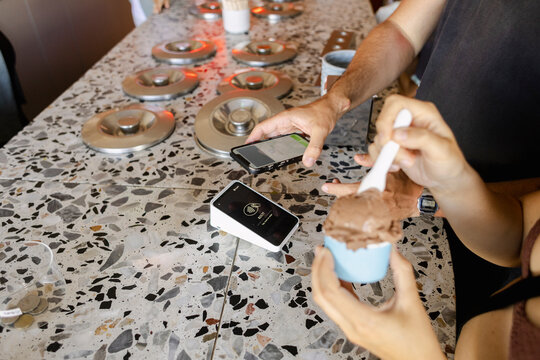 Paying for ice cream at a gelato shop