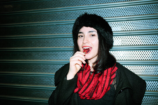 Woman eating lollipop portrait
