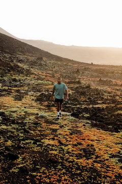 Professional runner training along a cross-country trail
