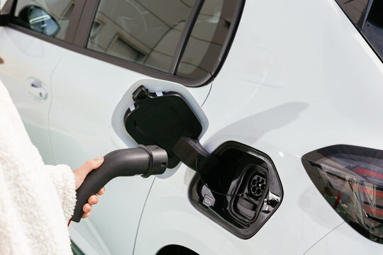 Hand plugging electric car for battery charging