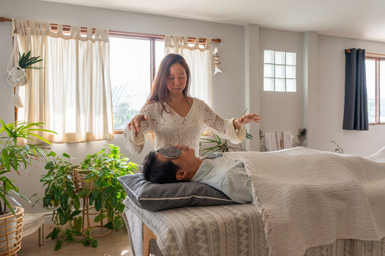 Woman Performs Healing Session Indoors at a Wellness Center