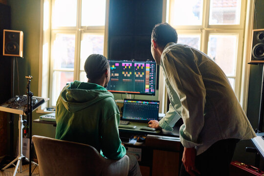 Music Producers Collaborating on Audio Project. Home Recording Studio