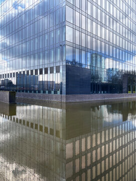 Modern Glass Office Building Reflecting on Canal Water