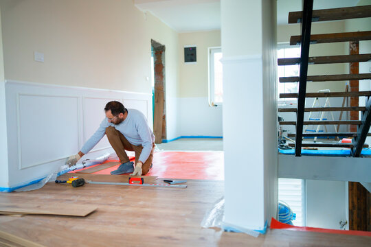 Man doing home renovation work in a hallway