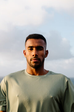 Portrait of a Black athlete posing outdoors with a determined gaze