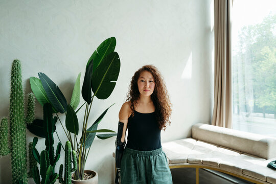 Woman Stands Confidently in a Bright, Modern Room With Plants