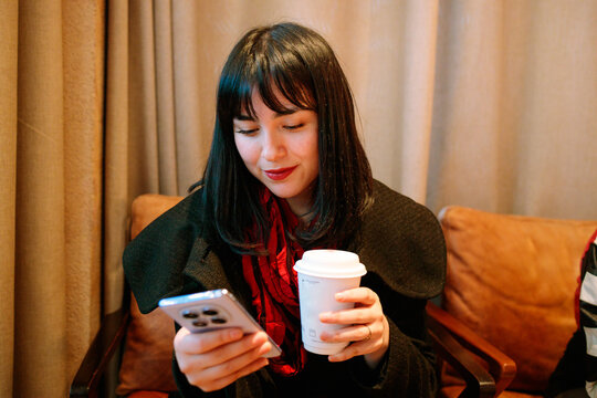Young elegant woman checking phone