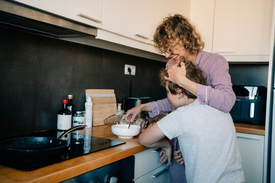 Cooking With a Child in a Modern Kitchen During the Day