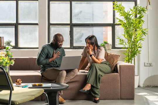 Colleagues Working on Laptop During Casual Business Meeting