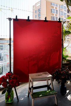 New Year-themed background filled with festive red hues, on balcony