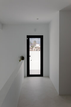 A modern minimalist hallway in white tones