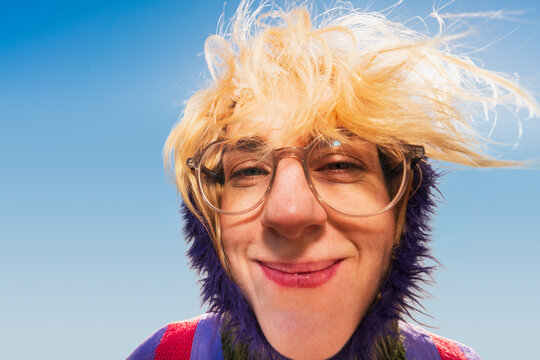 Extreme close-up of smiling woman with windblown hair outdoors