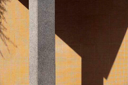 Abstract geometric shadows on tiled wall