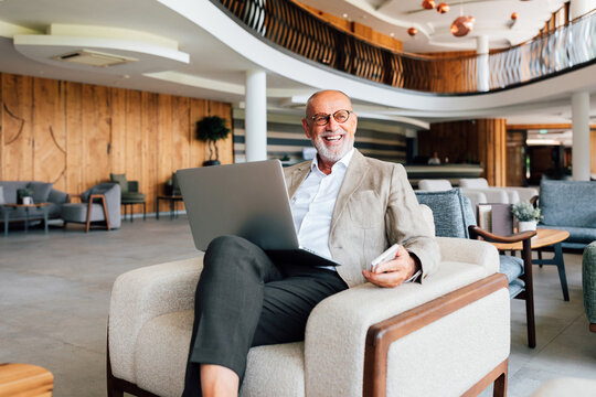 Business Senior Man Working in Hotel Lounge
