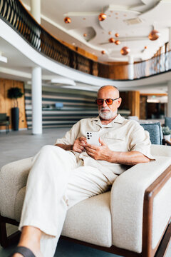 Business Senior Man on the Phone in Hotel Lounge