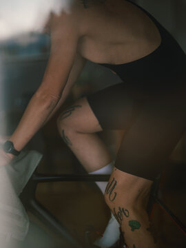 Tattooed Cyclist sprinting on his indoor bicycle