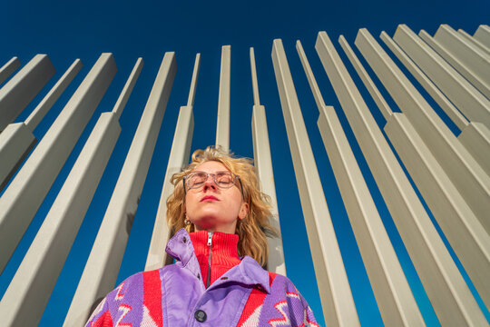 Low angle portrait of woman with closed eyes by columns