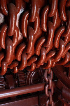 Heavy red industrial chains and machinery detail
