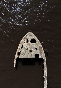 Close-up aerial view of damaged ship bow in water