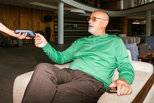 Business Senior Man Paying with Card