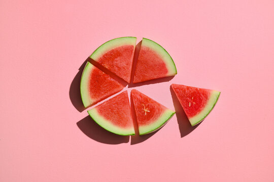 Slices of watermelon on a pink backdrop, perfect for a summer treat