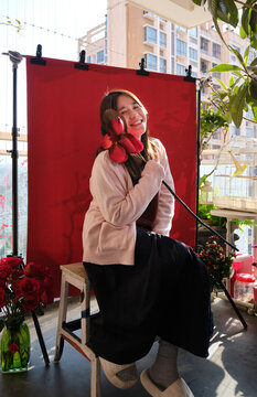 Chinese women on a balcony wiht red flower&mdash;Chinese New Year