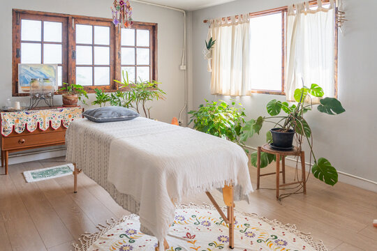 Massage Room With Plants and Sunlight in a Cozy Space