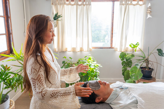 Woman Giving Healing Session in a Bright Indoor Space