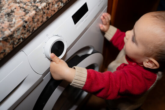 Child Turning Washing Machine Dial