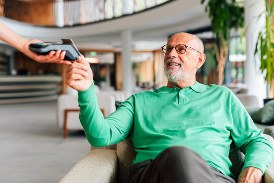 Business Senior Man Paying with Card