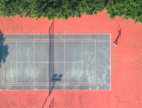 Aerial Top Down View of Tennis Player with Shadow on Court