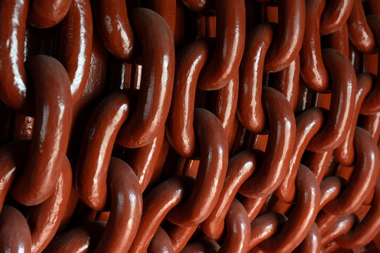 Abstract pattern of red metal chains in close-up