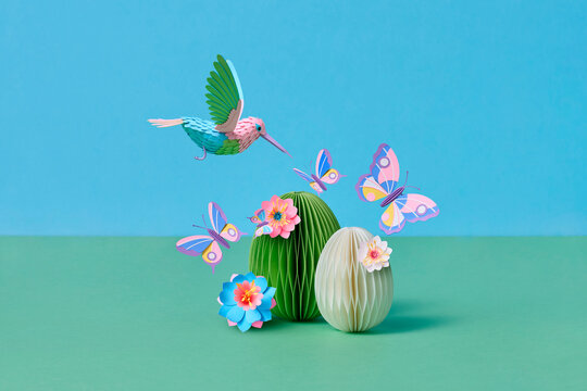 Paper hummingbird with butterfly and easter eggs