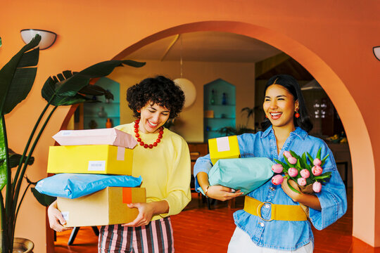 Friends enjoying packages, online shopping, and home deliveries ugc