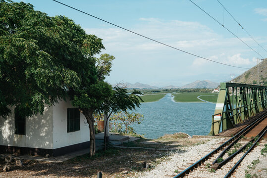 Railway bridge over river landscape with mountains in distance