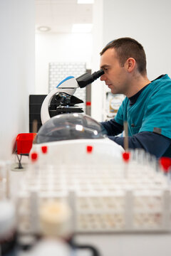 Scientist examines samples with microscope