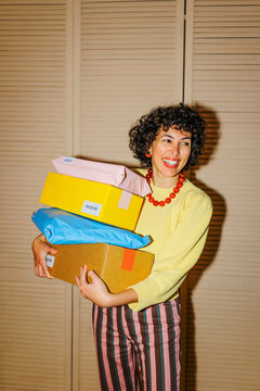 Woman carrying packages enjoying online shopping delivery ugc
