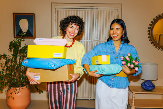 Happy women receiving home delivery packages and flowers ugc