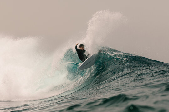 An elite surfer performing a re-entry on a wave