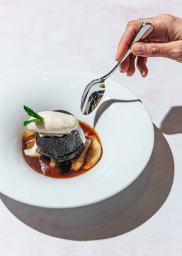 Spoon poking into a sticky toffee pudding