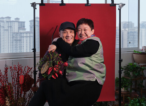 Chinese couples expressing their affection against a red background