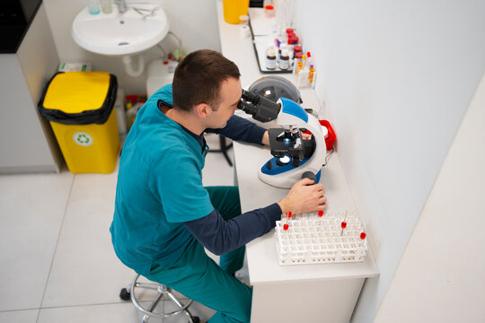Scientist uses microscope in a lab setting