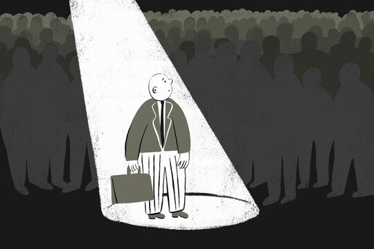 Man standing under a spotlight while others are just grey silhouettes