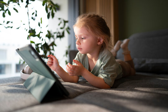 Child using tablet at home