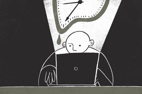 Man working on a laptop late at night 