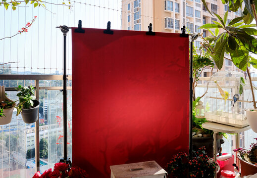 New Year-themed background filled with festive red hues, on balcony