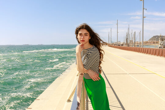 Woman Stands by the Pier With Ocean Waves
