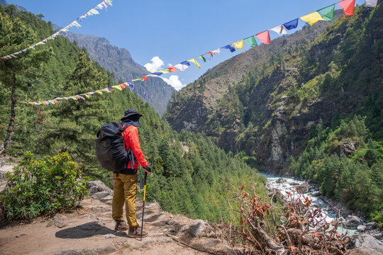 Solo hiker trekking through mountain valley on remote  journey